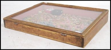 A large 20th century jewellery display case with hinged glass top with clasp having baize lined