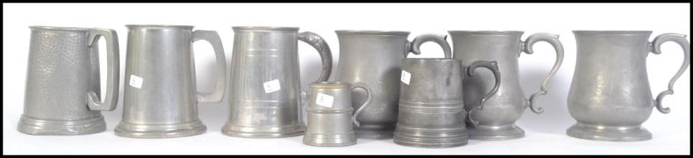 A collection of vintage late 19th and early 20th century pewter tankards to include three identical