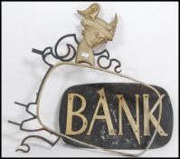 A stunning vintage early to middle 20th century advertising sign and forged mount.