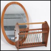 A vintage / retro teak wood oval frameless mirror together with a stunning magazine rack please see