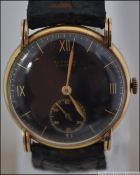 A gentleman's 14ct gold E Gubelin ( Lucerne ) black faced wristwatch.