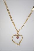 A hallmarked 9ct gold pendant necklace strung with a 9ct gold figural pendant set with a single