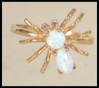 A hallmarked 9ct gold and opal and figural ring in the form of a spider.