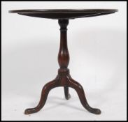 A 19th century Georgian country oak tilt top side / wie table raised on a splayed leg tripod base
