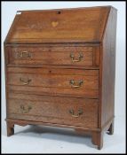 A 1920's Arts & Crafts oak bureau having fall front slope with appointed interior set within and