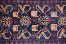 A small early 20th century Persian handwoven rug having central panel of medallions to a black and