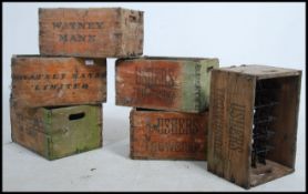 A stack of vintage mid century wooden advertising beer bottle crates,