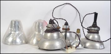 A group of five retro 20th century brushed aluminium pendant conical light fixtures / shade.