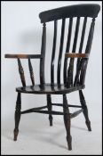 A Victorian beech and elm Windsor chair raised on turned legs with stretchers having saddle seat