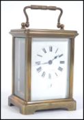 An early 20th century brass carriage clock with enamel dial,