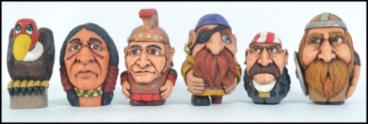 A collection of 6 impressive hand carved and crafted wooden figurines - heads to include Roman