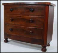 A Victorian mahogany bow front straight 3 chest of drawers being raised on turned legs,