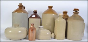 A collection of vintage early 20th century stoneware advertising pots and flagons,