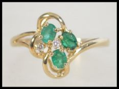 A 9ct gold diamond and green stone ring. Size T.5. Weight 2.1g. Marked 9K tests 9ct gold.