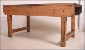 A large mid 20th century Industrial type scratch built pine four plank workbench / table having