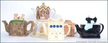 A collection of novelty teapots to inclu