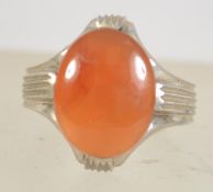 A silver white metal ladies dress ring with large central amber oval cut stone being signed to the