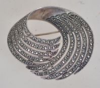 A 925 silver Art Deco Style swirl brooch set with marcasite with roller clip clasp. Weight 18.9g.