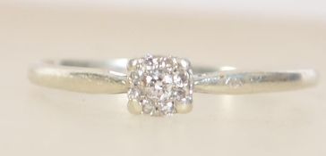 A hallmarked 9ct white gold and diamond cluster ring. Hallmarked for London. Size P.