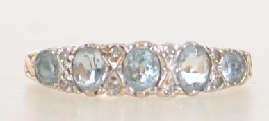 A vintage hallmarked London 9ct gold ring with 3 blue oval cut topaz with illusion set diamonds and