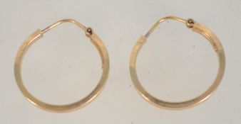 A pair of 9ct gold hoop earrings with etched star decoration and lever clasp backs. Marked 375.