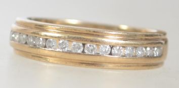 A hallmarked 9ct gold and diamond channel set ring. The diamonds approx 25pnts.