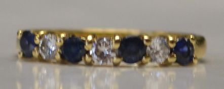 A hallmarked 18ct gold, blue sapphire and diamond ring. Hallmarked for London.