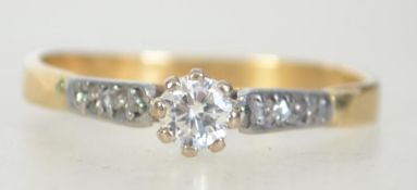 A marked 18ct solitaire diamond ring with diamond set shoulders. Diamonds approx .20pts. Weight 2.