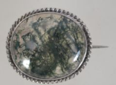 A Victorian silver mounted moss agate brooch with c clasp. Measures approx 1.5 inches.