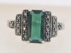 A silver 925 Art Deco style ladies dress ring with central baguette green stone with marcasite step