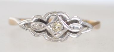 An Art Deco 9ct gold and platinum diamond ring.