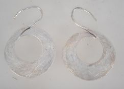 A pair of silver hoop earrings with hook backs. Measures 2 inches. Tests silver.