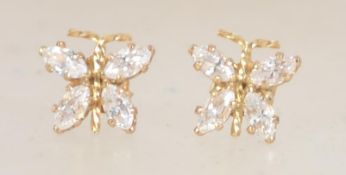 A pair of 9ct gold stud earrings in the form of butterflies with post backs set with clear stones.