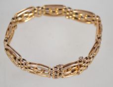A 9ct gold bracelet of bar link form complete with the safety chain. Measures 7 inches. Weight 12.