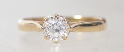 A 9ct gold single stone diamond ring being prong claw mounted and illusion set.