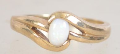 A hallmarked 9ct gold and opal ring with pierced crossover design with oval opal. Size P. Weight 2.