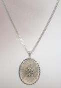 A hallmarked 925 silver locket pendant necklace with rope twist surround engraved flowers and