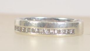 A 9ct white gold band ring set with 16 2pt cushion cut diamonds. Hallmarked for Birmingham.