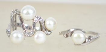 Two silver 925 ladies dress rings of similar form both having cultured pearls and white paste