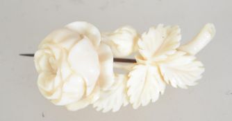 A Victorian carved ivory brooch pin in the form of a rose spray with c clasp. Measures 4 cms.