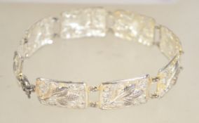 A vintage 800 silver pictorial link bracelet with spring hoop clasp. Marked 800. Measures 7.