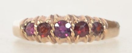 A Victorian hallmarked Chester 1895 9ct gold ring with 5 garnet stones in a gypsy setting. Size L.