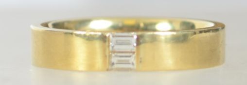 A hallmarked contemporary 18ct gold and diamond band ring,
