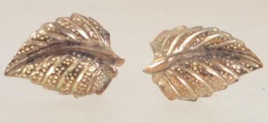 A pair of 9ct gold stud earrings with in the form of leaves with post backs. Marked 9ct.