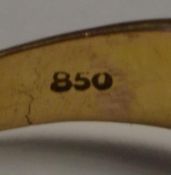 A gold and diamond ring with central 20 pt diamond surrounded by concentric circles of 5pt and 2pt