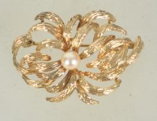 A hallmarked 9ct gold and pearl brooch with trombone clasp. Import marks for London. Maker H.G.