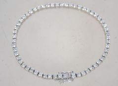 A hallmarked 18ct white gold and diamond tennis bracelet set with a total of 3cts diamonds.