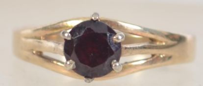 An Art Deco 9ct gold and silver ring set with a red stone Marked 9ct and Sil. Tests 9ct and silver.