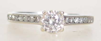 A hallmarked 9ct white gold diamond solitaire ring the diamond being set within a collet mount