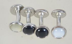 Four vintage white metal shirt studs cufflinks with mother of pearl and black end caps. Weight 8.9g.